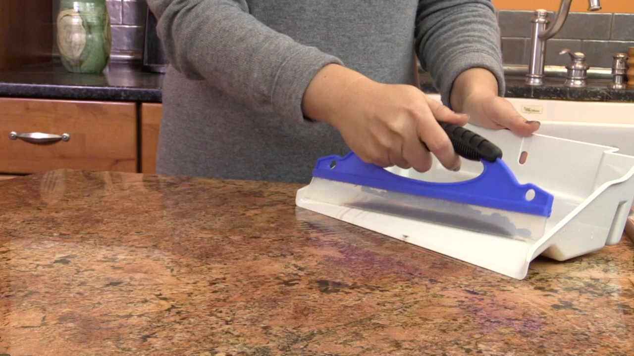 image of a woman using Orangutize Grab and Go cleanup tool to clean black beans